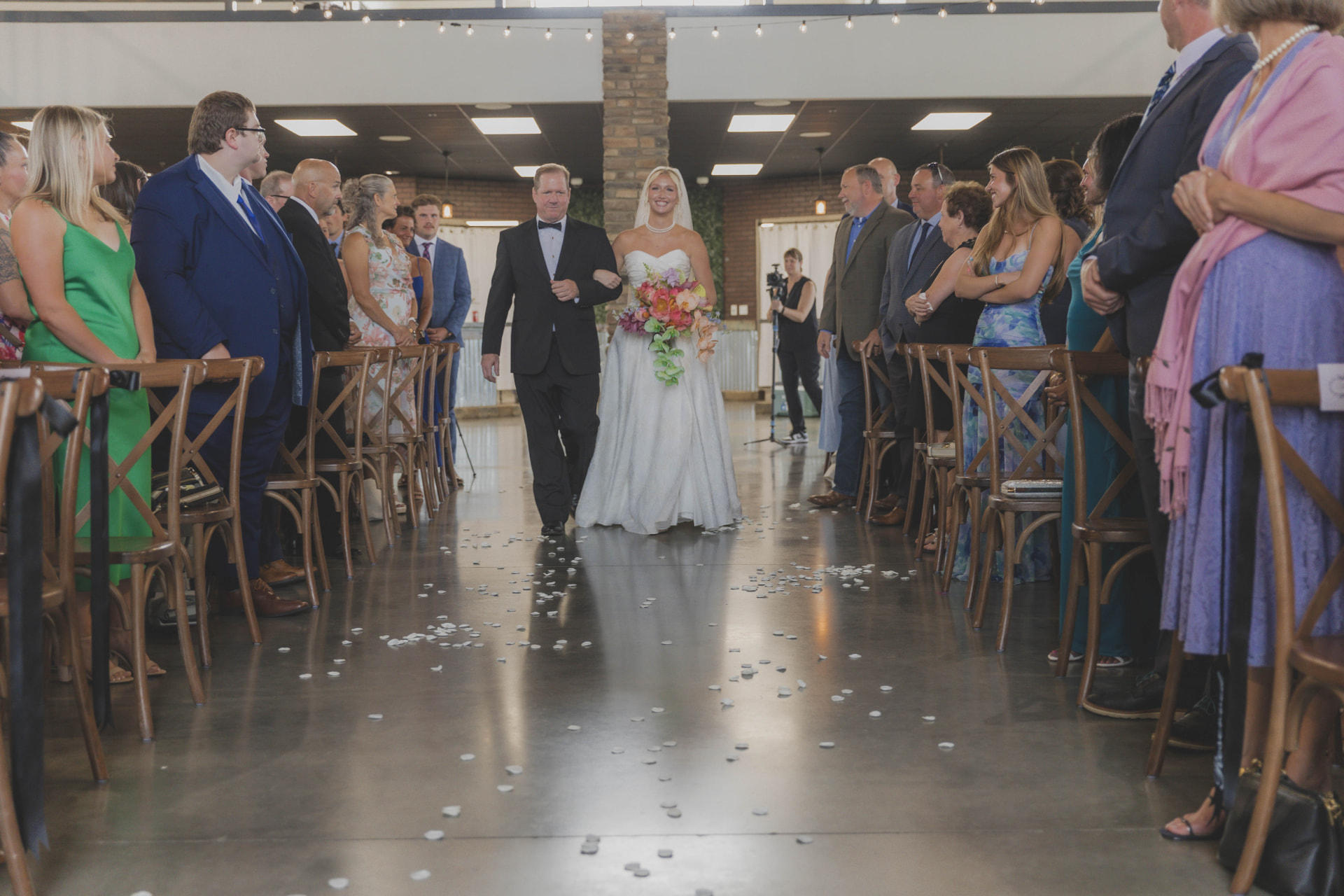 Bride walking down the aisle with her father at a mid-Missouri wedding ceremony